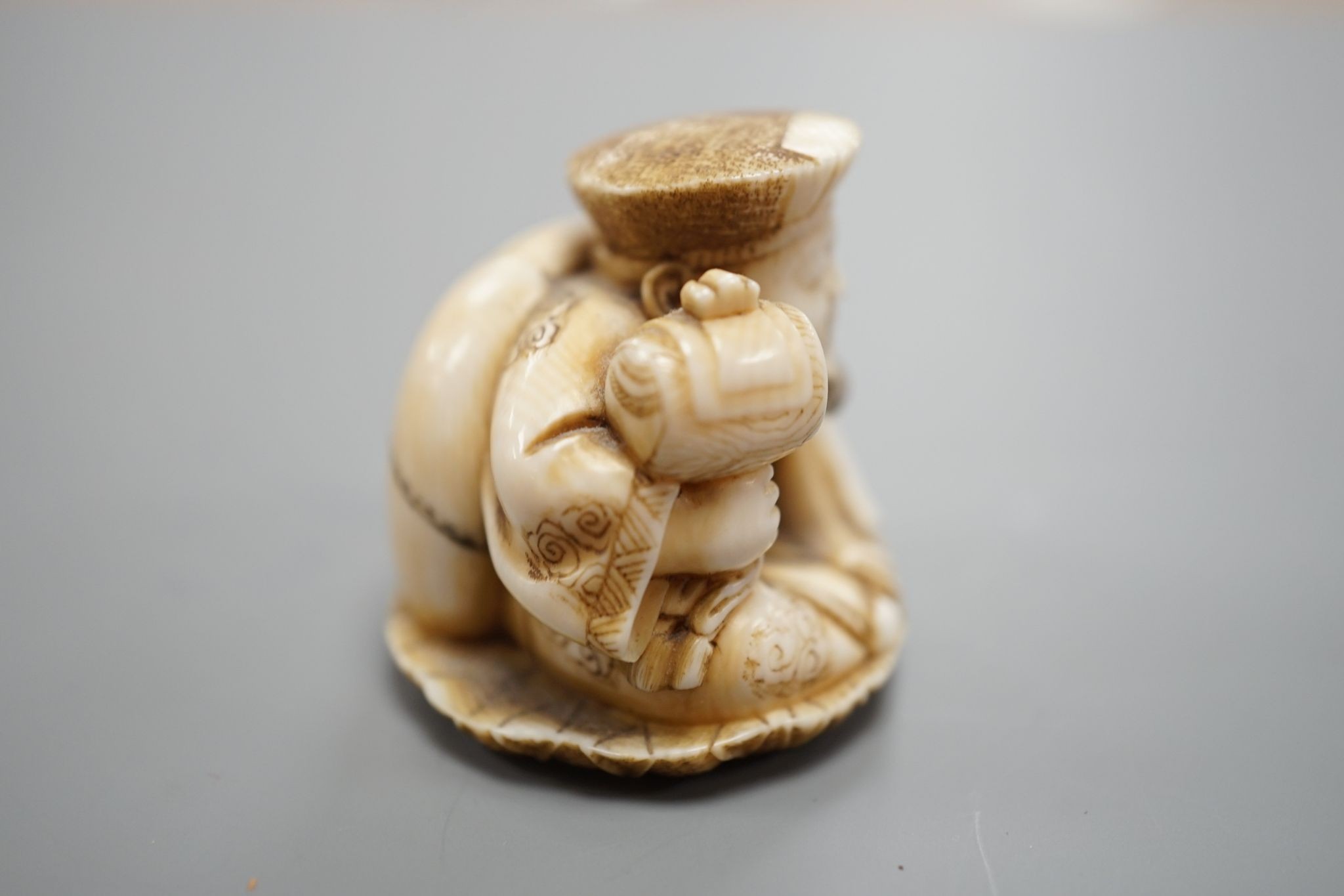 A Japanese ivory netsuke of Daikoku, Meiji period, 3 cms high.